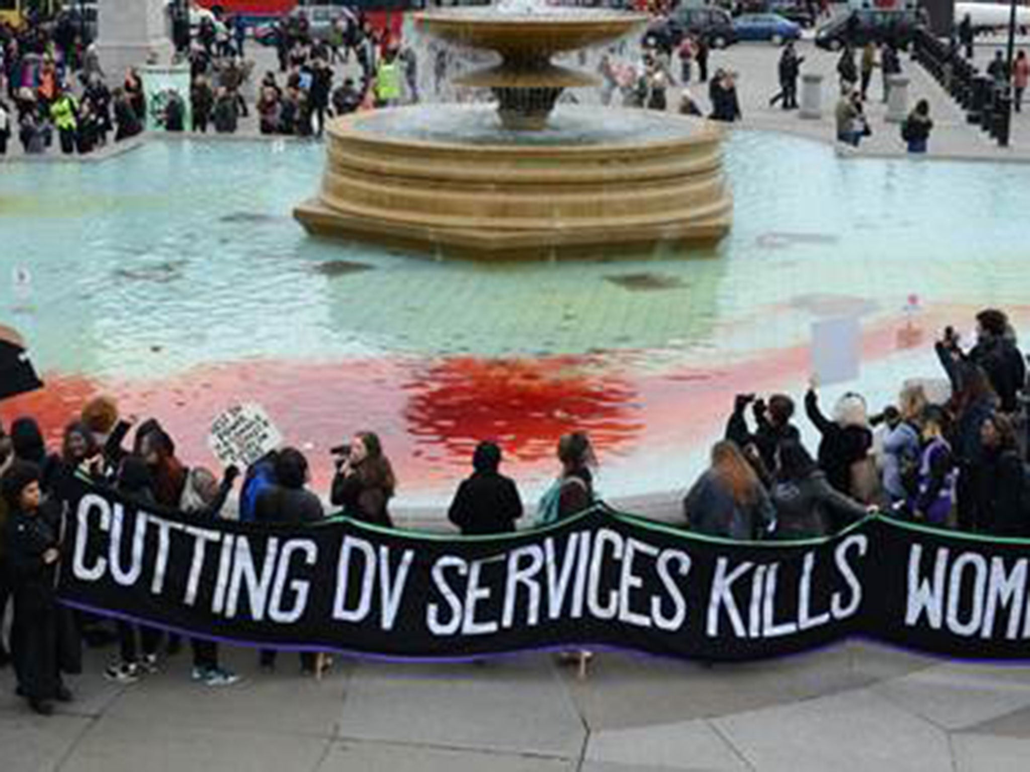 Trafalgar Square fountains dyed blood red as Sisters Uncut demonstrators protest against budget