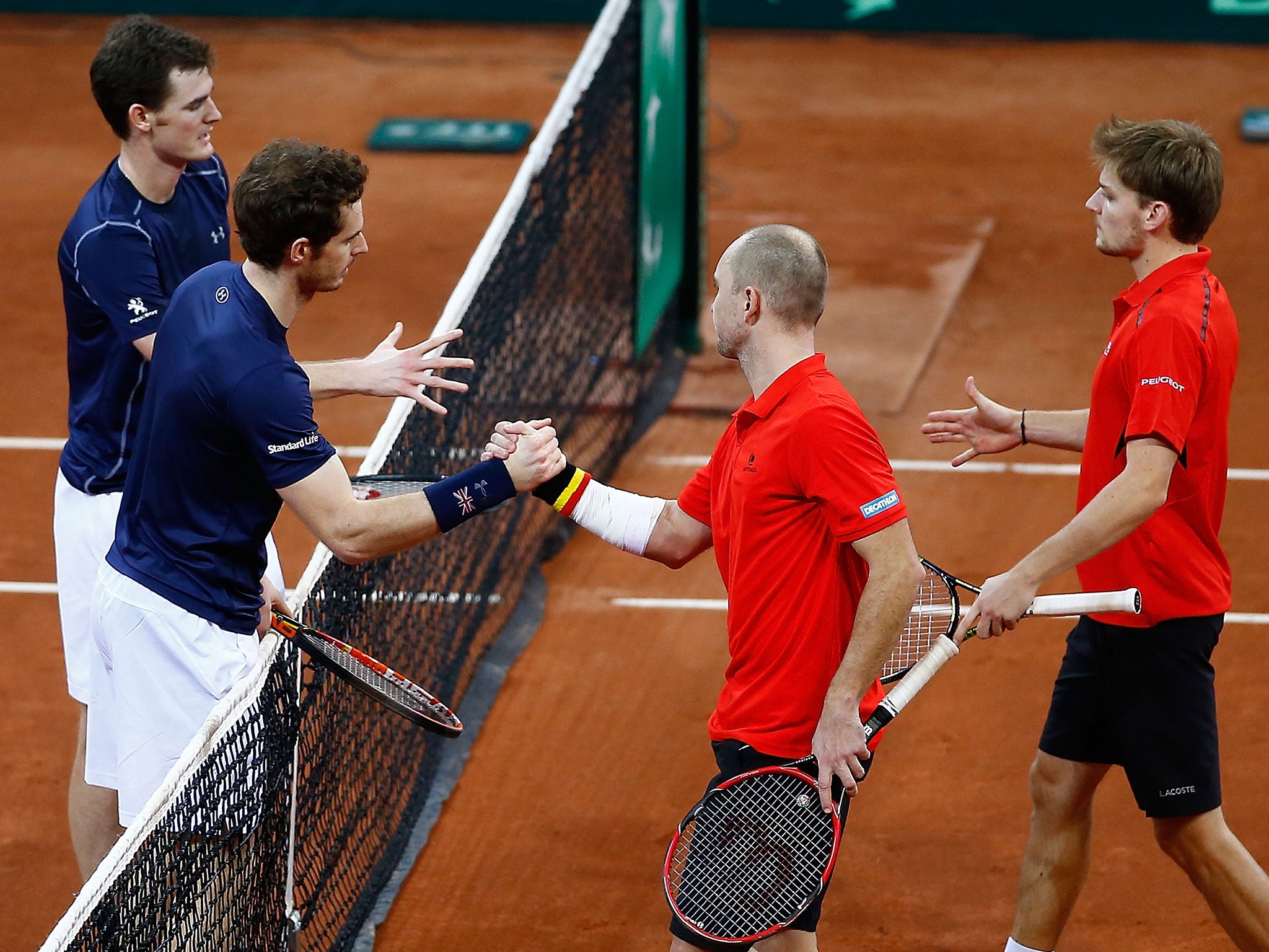 Andy and Jamie Murray shake hands with Steve Darcis and David Goffin after beating them in the Davis Cup