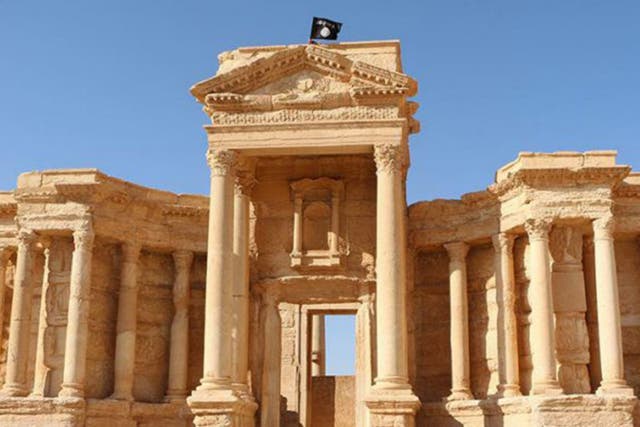 An Islamic State flag flies over the Roman theatre in Palmyra. The group have now been driven from the site.