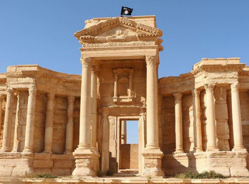 An Islamic State flag flies over the Roman theatre in Palmyra. The group have now been driven from the site.