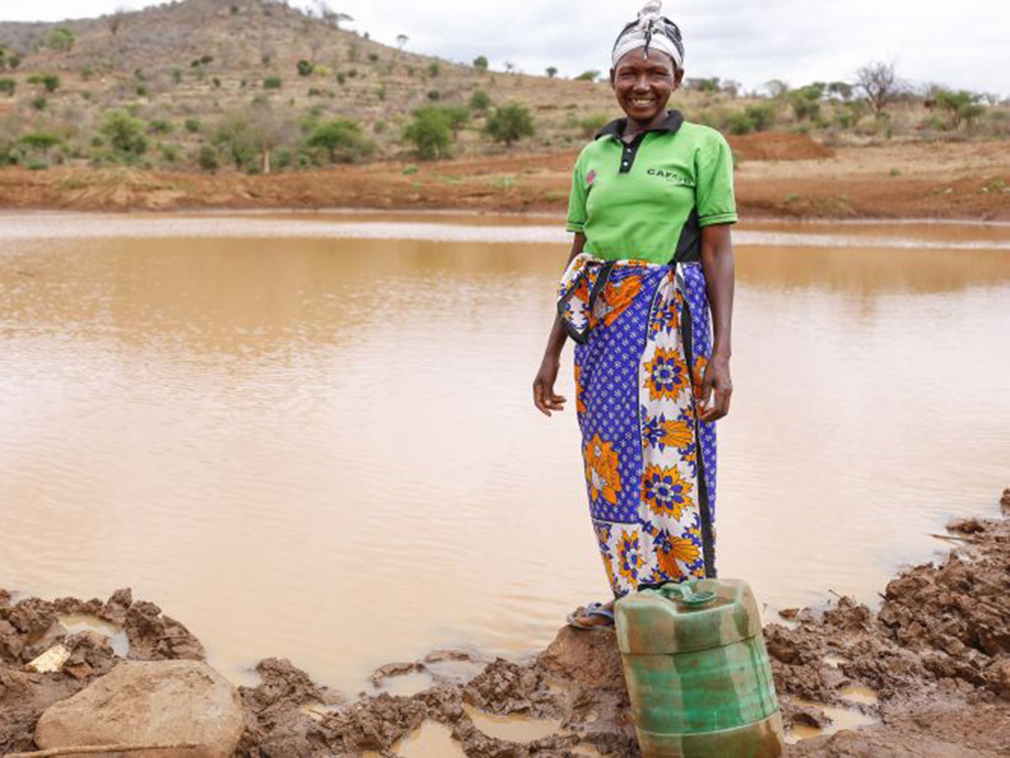 Tabitha Paul stands next to the incomplete Musosya dam in Musosya village, Kitui