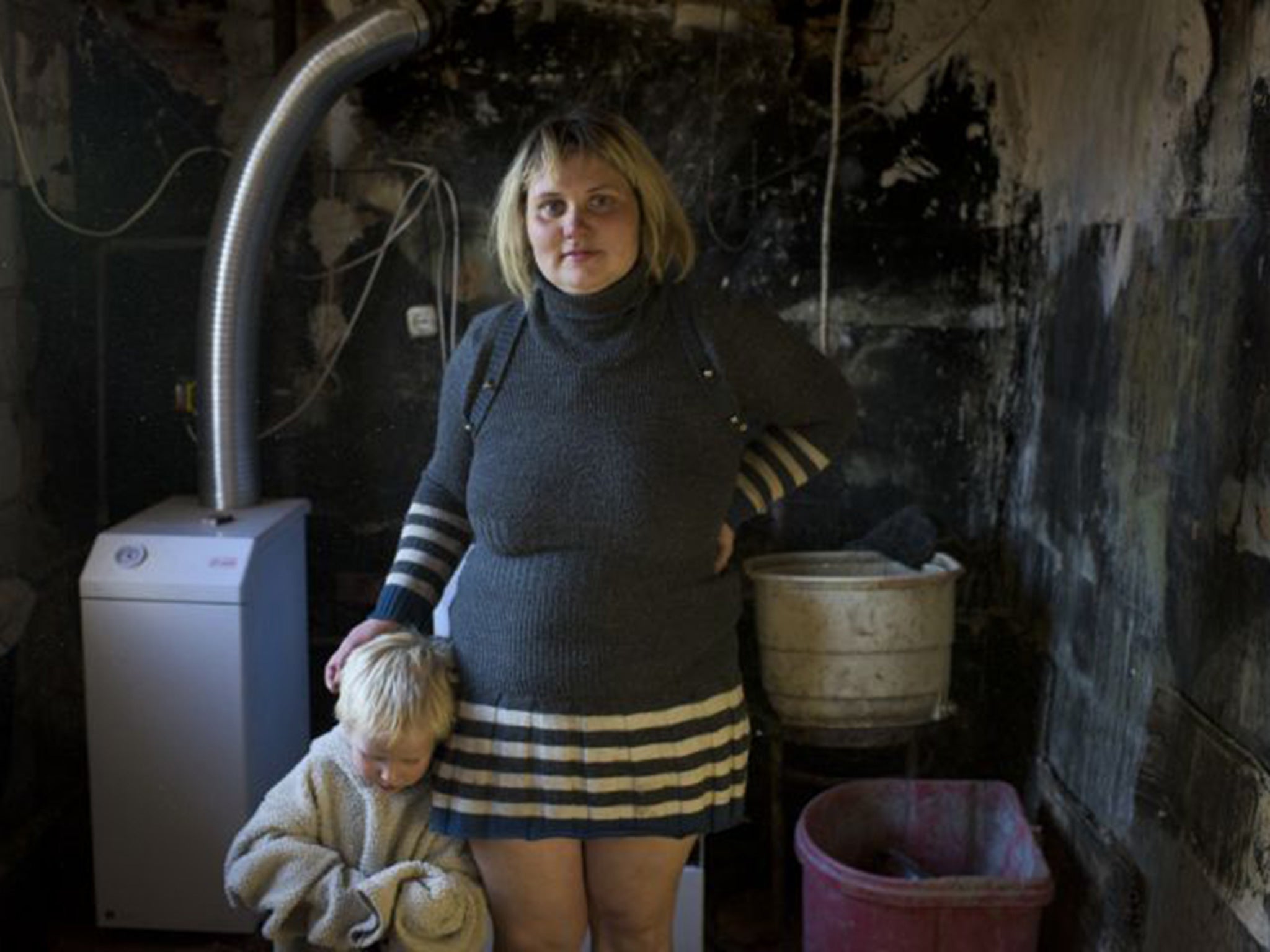 Single mother of five Natalia Svergun in her home, which has been gutted by shell fire