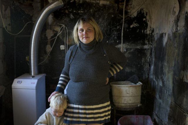 Single mother of five Natalia Svergun in her home, which has been gutted by shell fire