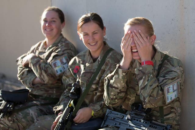 British female troops share a joke aat Kandahar airfield in Afghanistan