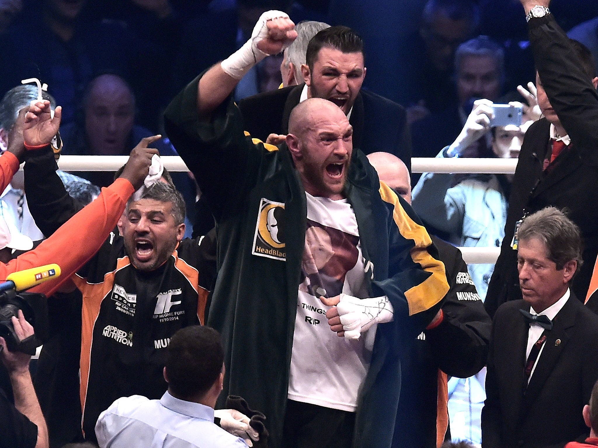 Tyson Fury celebrates in the ring after hearing he had won the belts