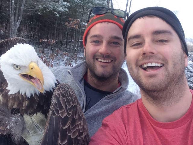 Michael and Neil Fletcher pose for a selfie with the bald eagle they rescued near Windy Lake