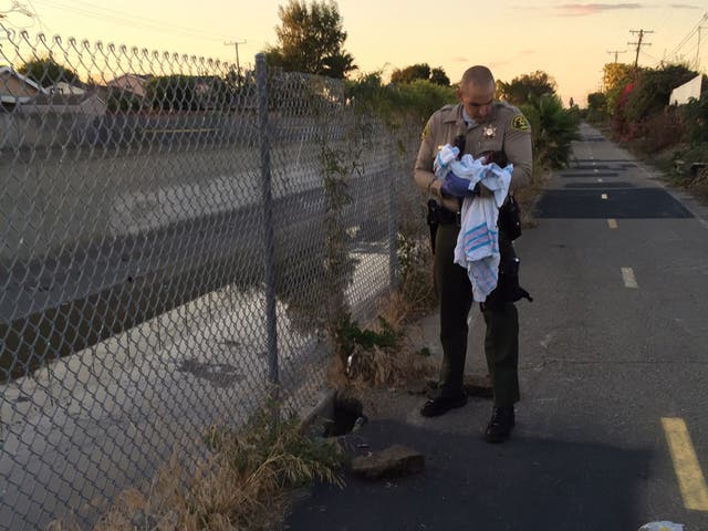 Two officers removed the pieces of asphalt and debris off the baby