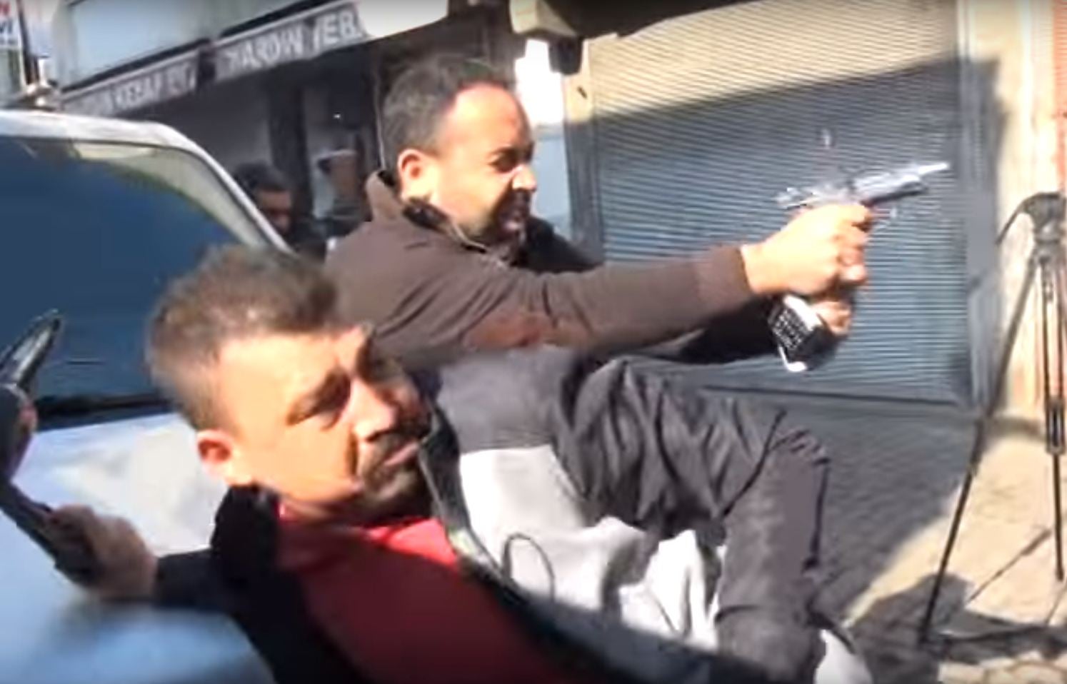 Plain-clothed police fire at a suspect during the gun battle that saw Tahir Elci killed
