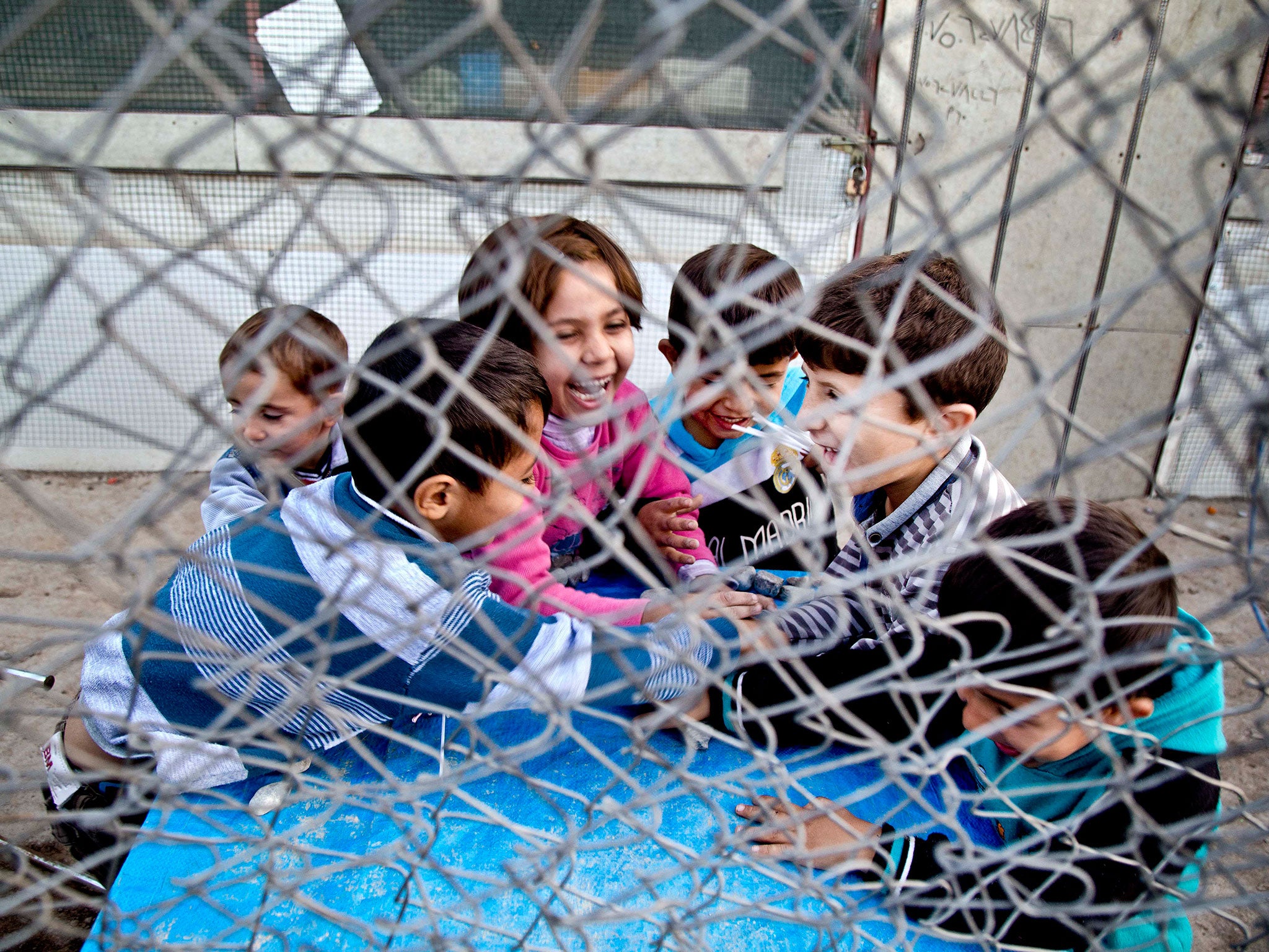 Syrian refugee children play at a temporary refugee camp in Irbil, northern Iraq