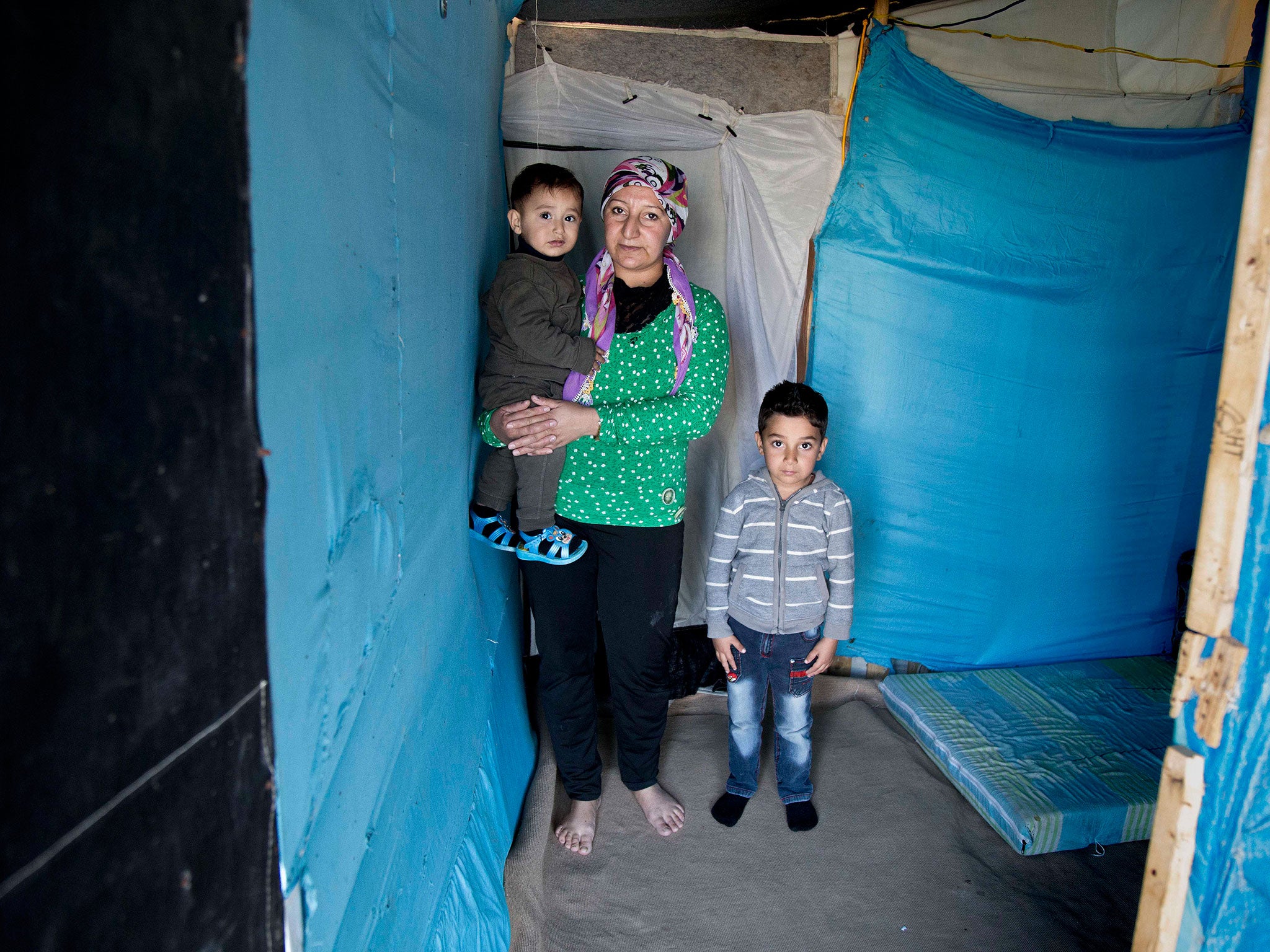 Syrian refugee Yasra Mohammad poses for a photograph with her children