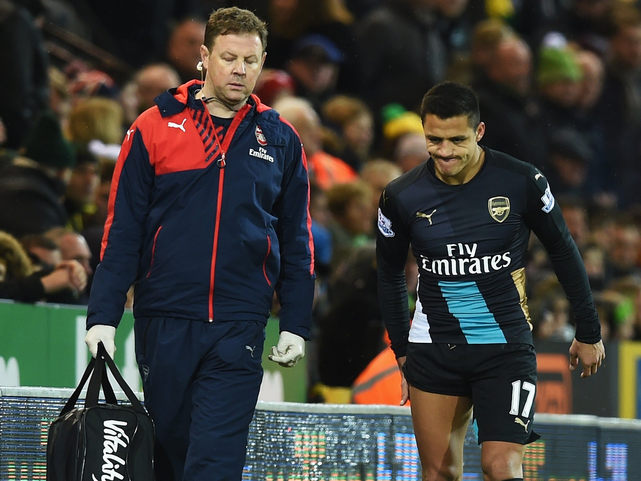 Alexis Sanchez limps off down the tunnel at Carrow Road