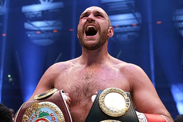 &#13;
Tyson Fury holds his new belts&#13;
