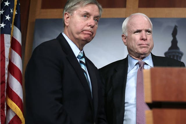 US Senator John McCain (R), and Senator Lindsey Graham (L) speak during a news conference on the Benghazi terror attack on 14 February, 2013