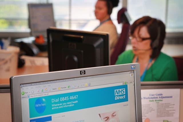 Workers take calls at a National Health Service call centre