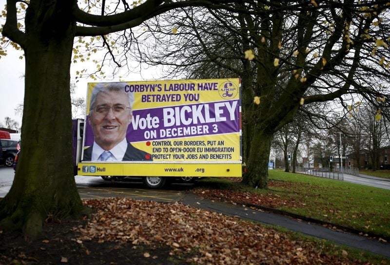 A poster featuring UKIP party candidate John Bickley stands in a car park outside Royton Market near Oldham