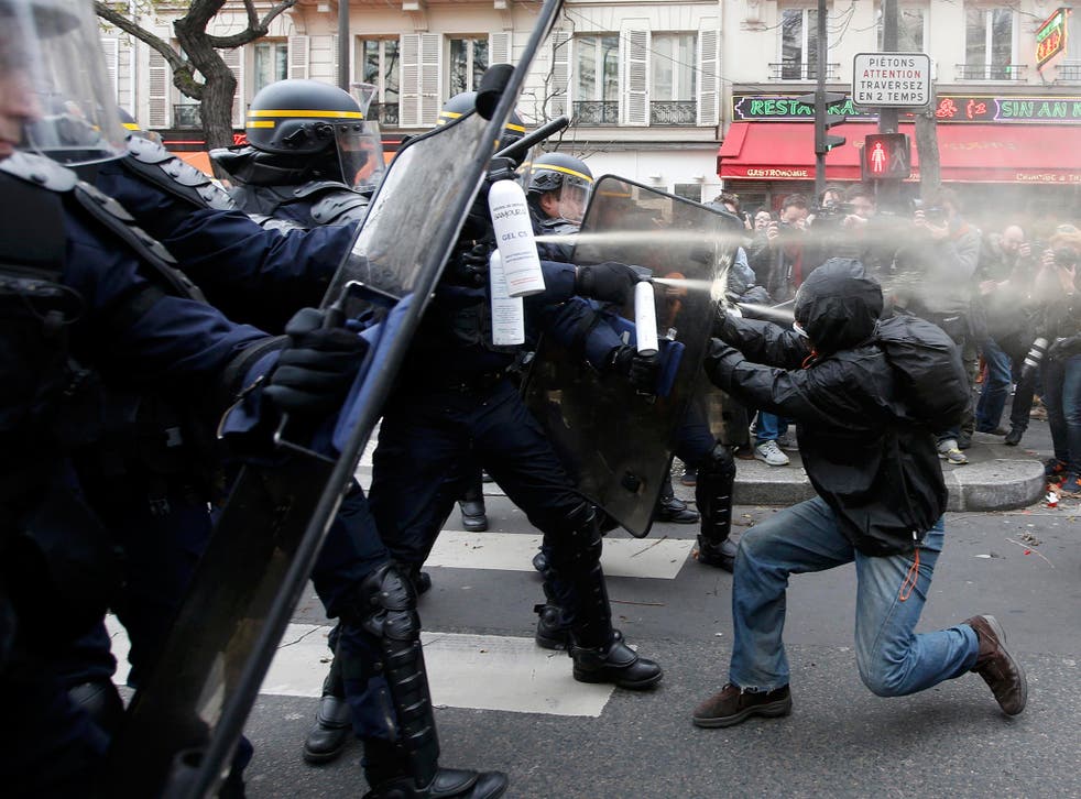 Demonstrators clash with CRS riot policemen near the Place de la Republique after the cancellation of a planned climate march following shootings in the French capital, ahead of the World Climate Change Conference 2015 (COP21), in Paris, France