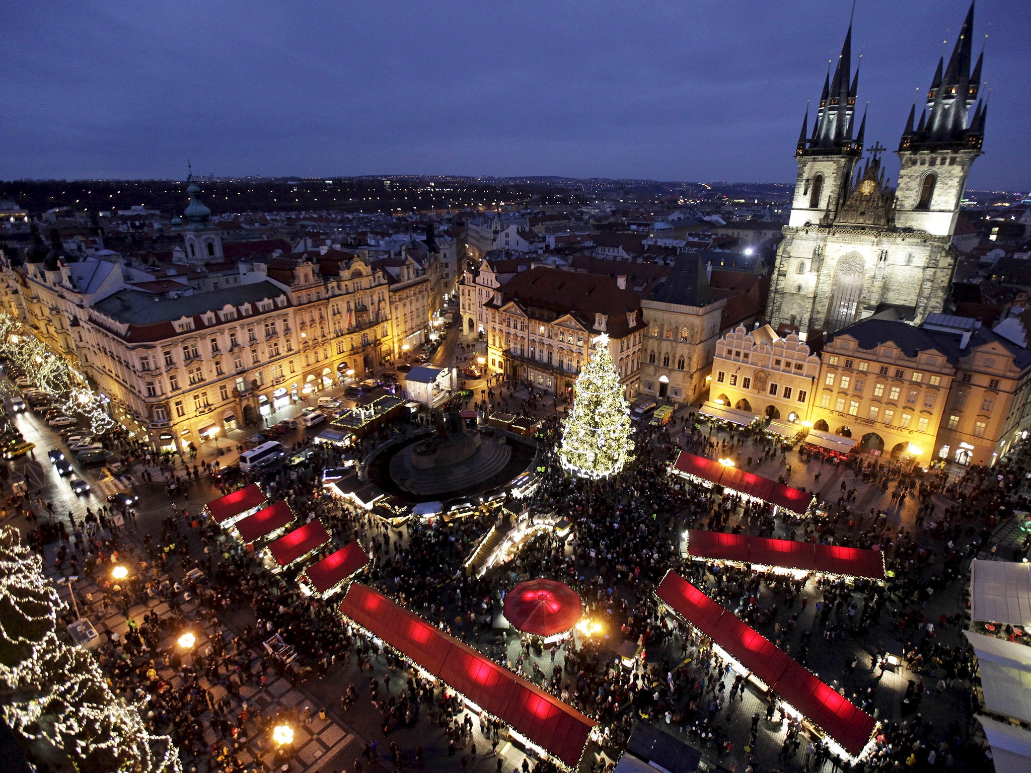 A Christmas tree is illuminated as the traditional Christmas market opens at the Old Town Square in Prague, Czech Republic
