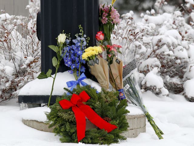 Flowers left at an intersection near the Planned Parenthood clinic in Colorado Springs. Gunman Robert L. Dear stormed the clinic on Friday and killed three people, including a police officer