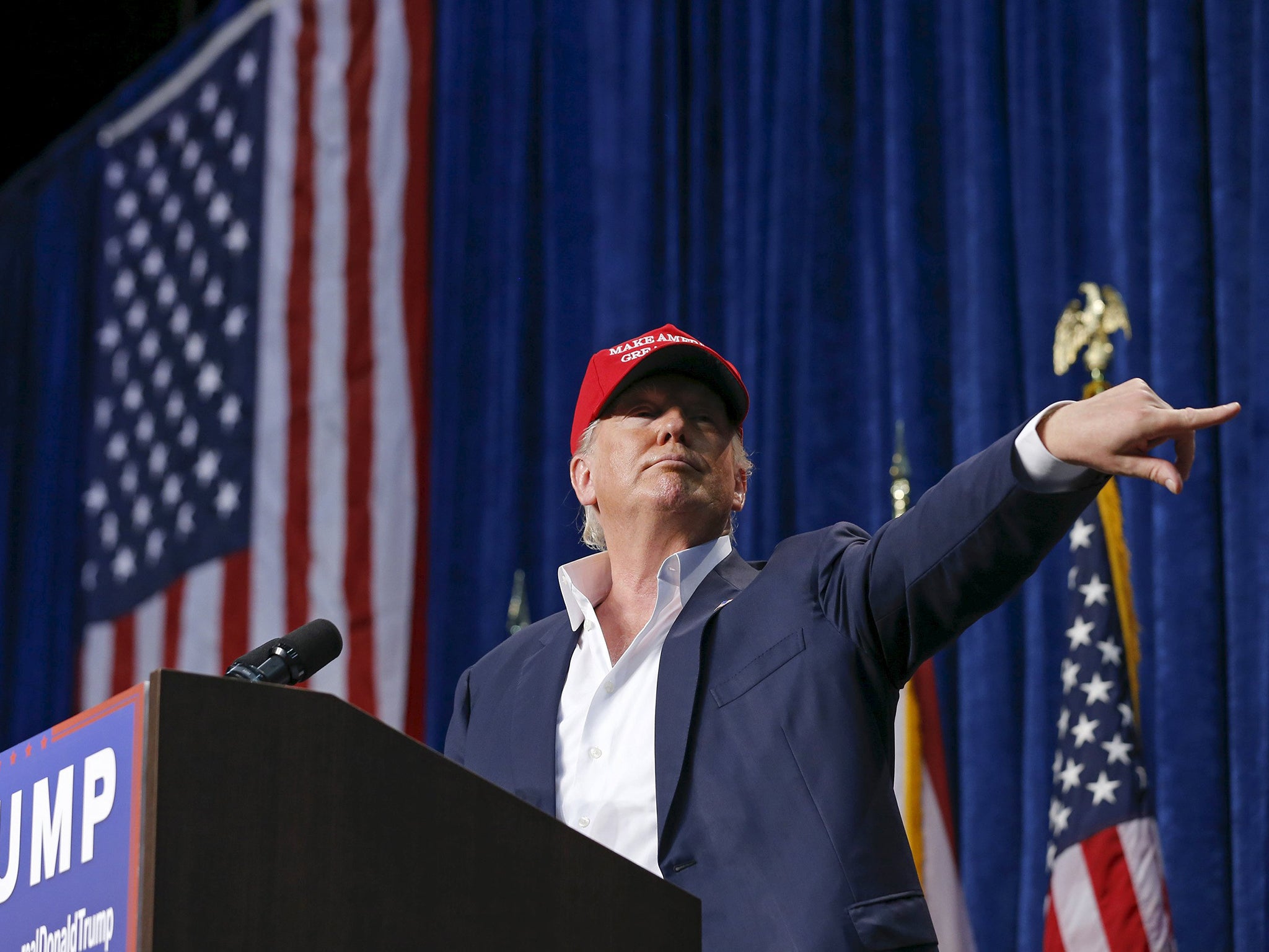 U.S. Republican presidential candidate Donald Trump motions for security to remove a person from his rally in Sarasota, Florida