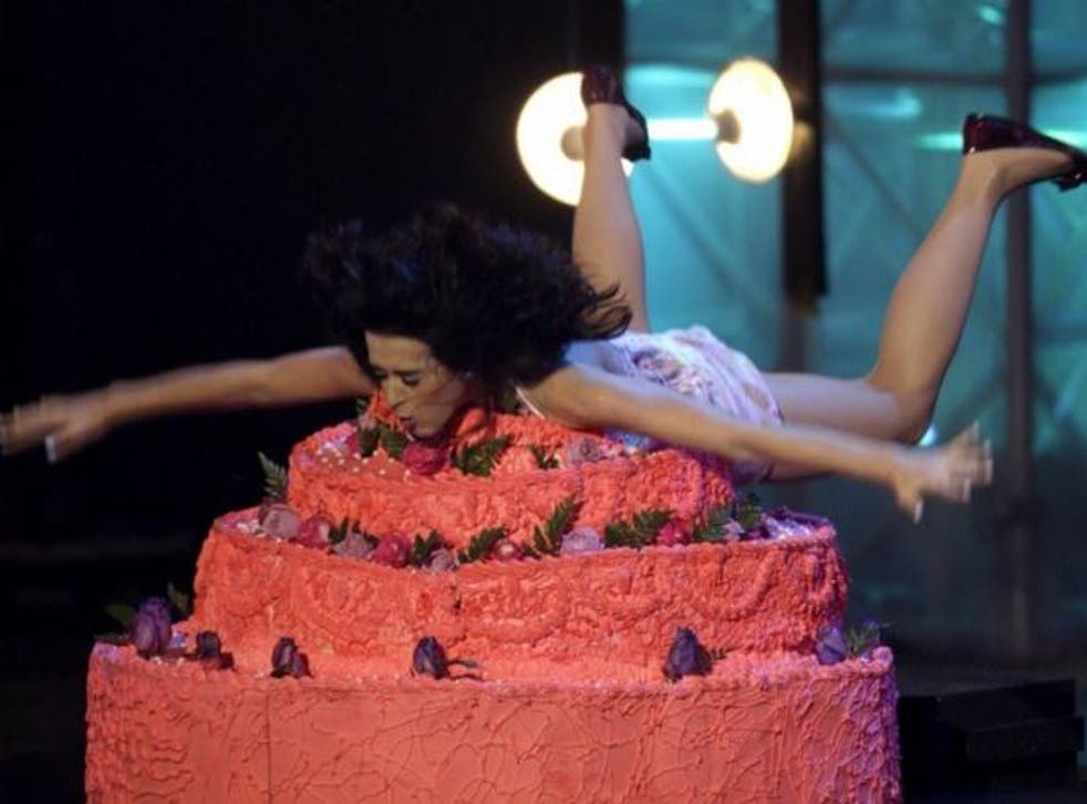 Katy Perry dives headfirst into a cake while performing at the MTV Latin America VMAs