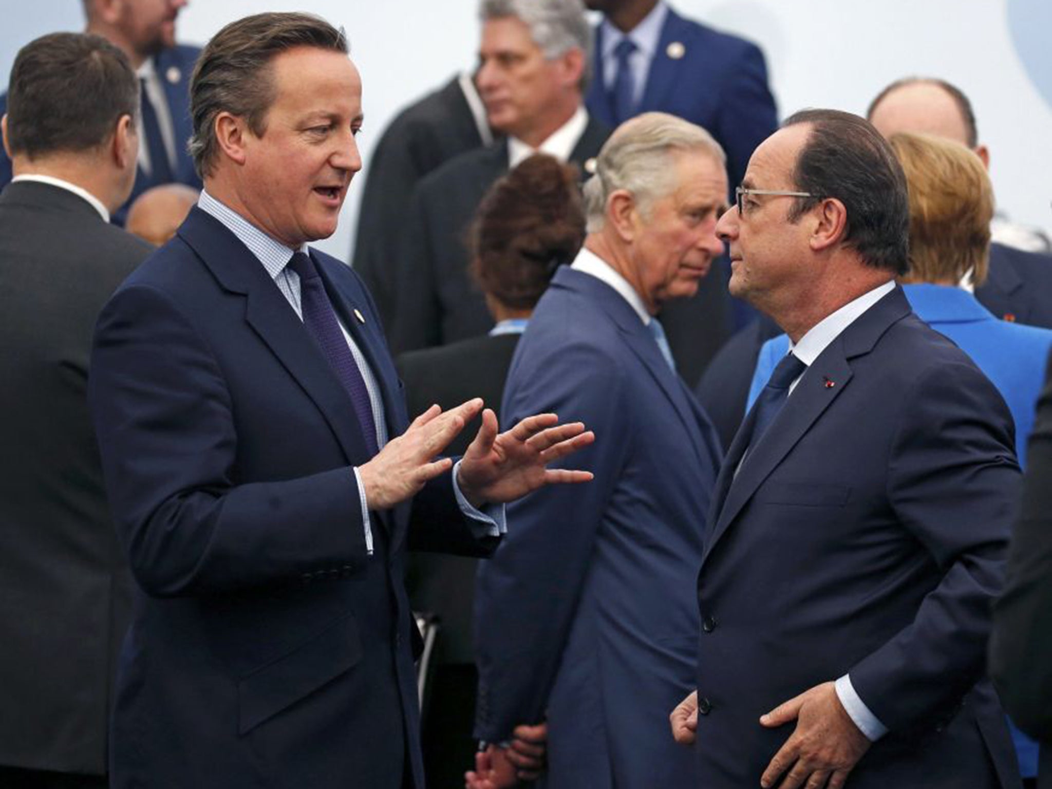 David Cameron talks to Francois Hollande as Prince Charles looks on in Paris
