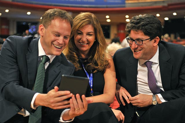 Grant Shapps, left, with Lord Feldman (pictured with Karen Brady, centre) at the Tory conference in 2014