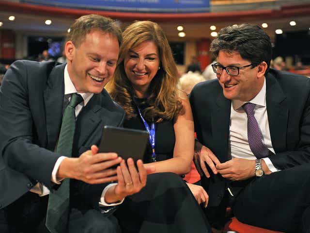 Grant Shapps, left, with Lord Feldman (pictured with Karen Brady, centre) at the Tory conference in 2014