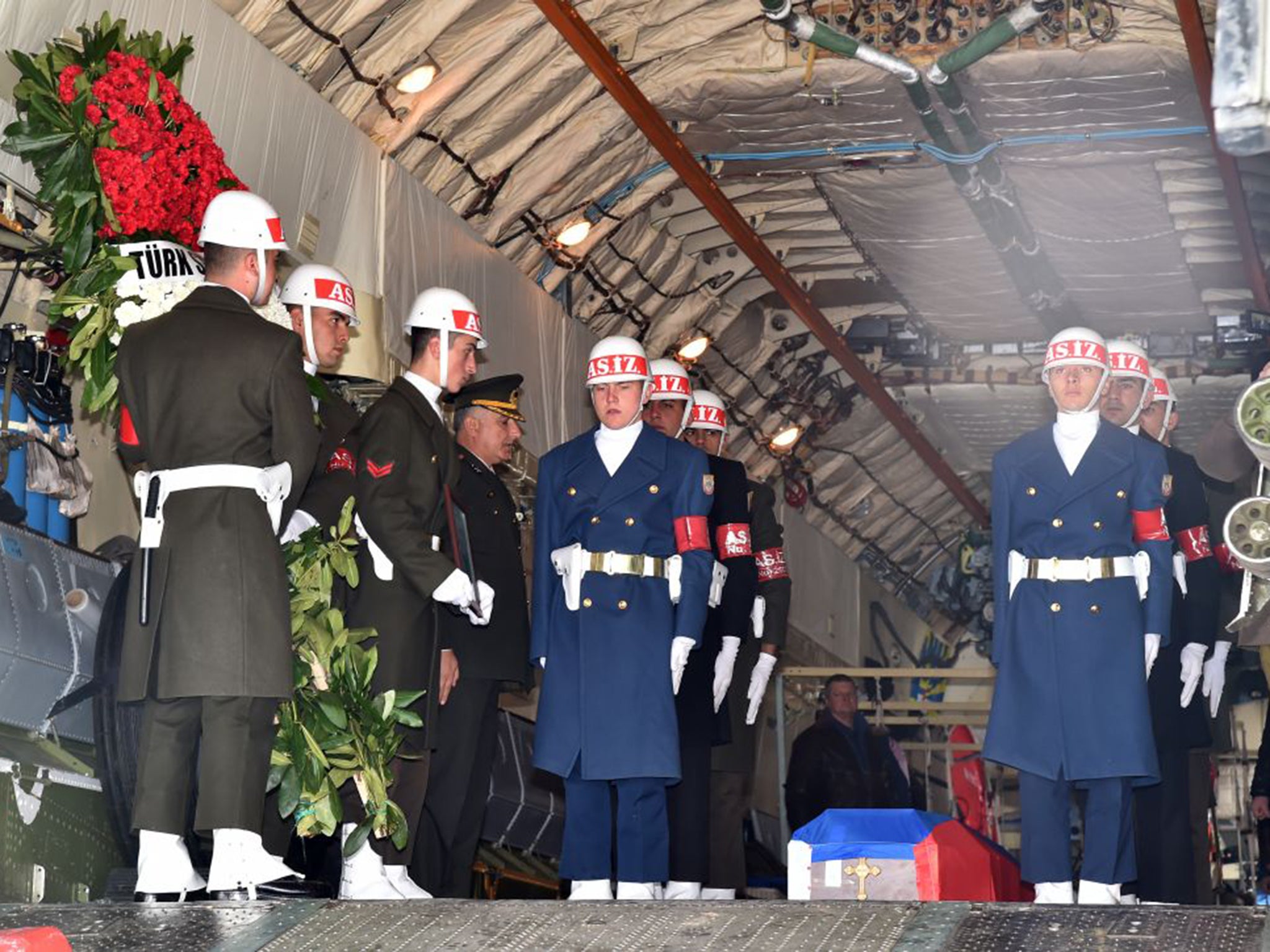 Turkish honour guards accompany the coffin of a Russian pilot whose plane was shot down last week