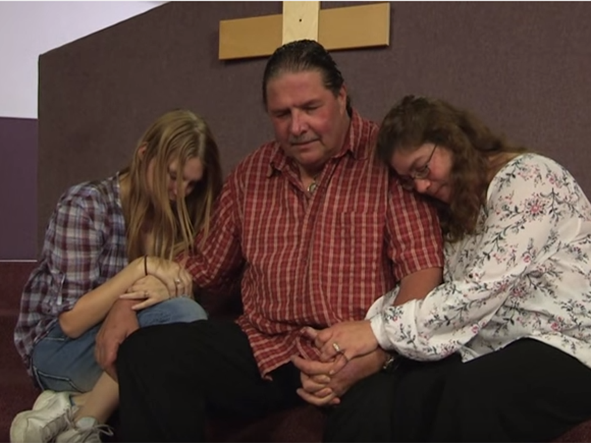 Thom Miller prays in his church with wives, Reba and Belinda