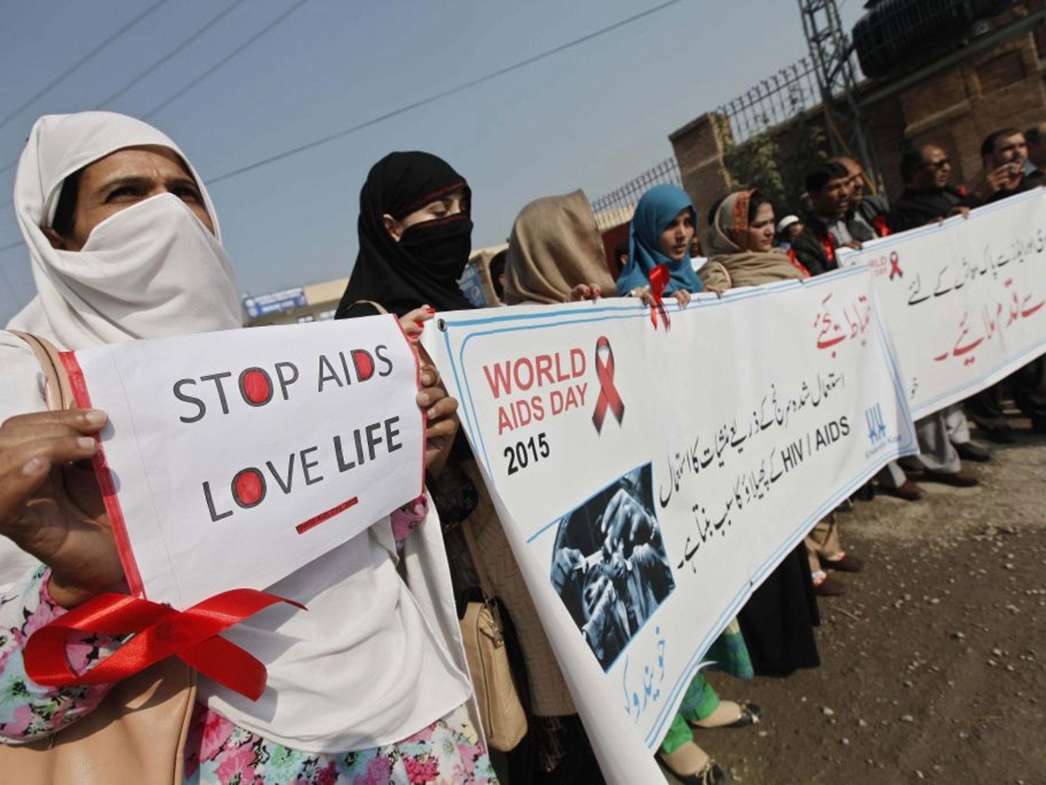 Pakistani protesters rally on World Aids day in Peshawar (EPA)