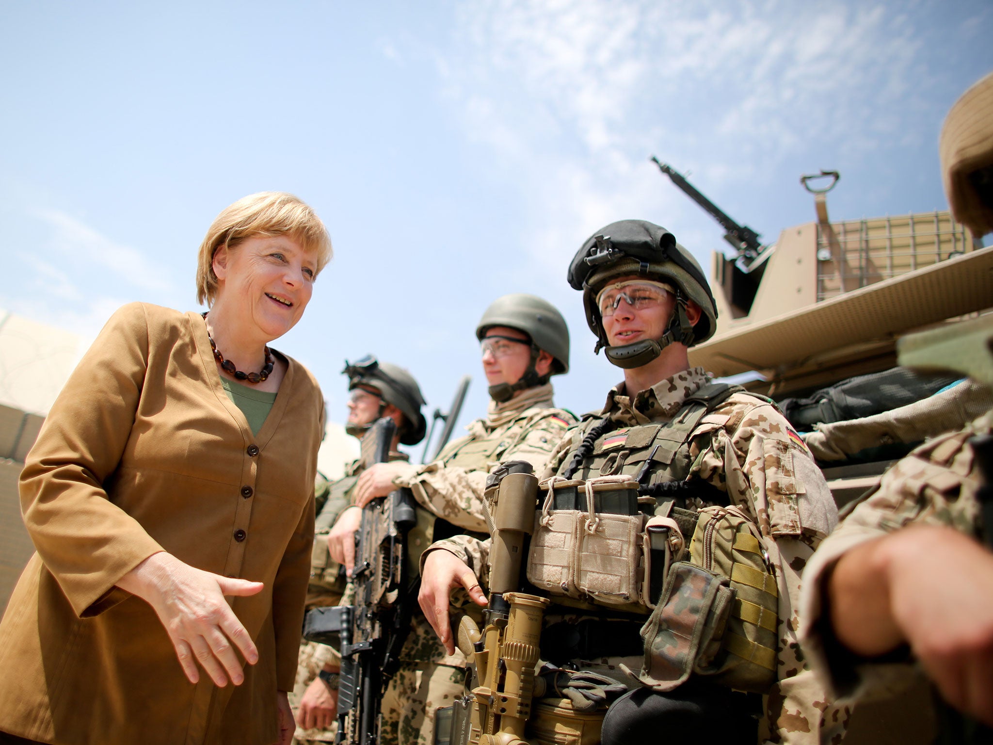 German Chancellor Angela Merkel shakes hands with soldiers of the German armed forces Bundeswehr during her visit on May 10, 2013 at the Bundeswehr base in Kunduz, Afghanistan.
