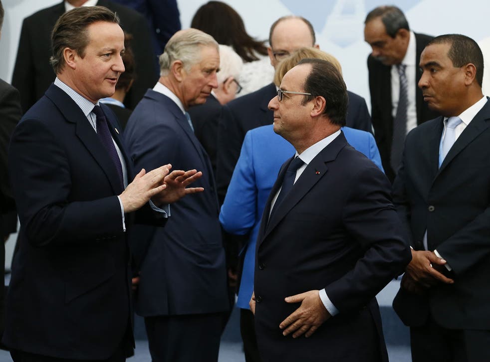 Britain's Prime Minister David Cameron (L) speaks with French President Francois Hollande (C) as they arrive for the family picture at the COP21 World Climate Change Conference in Paris