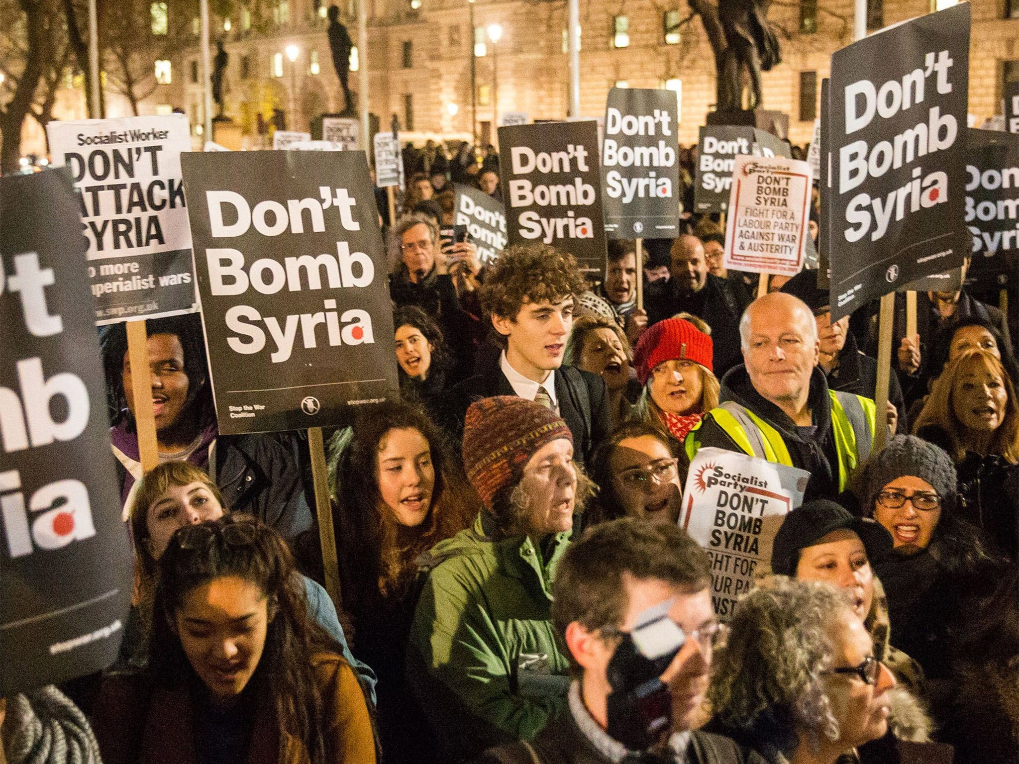 'Stop the War' supporters protest against plans to extend British air strikes against Isis from Iraq into Syria, in Parliament Square, London