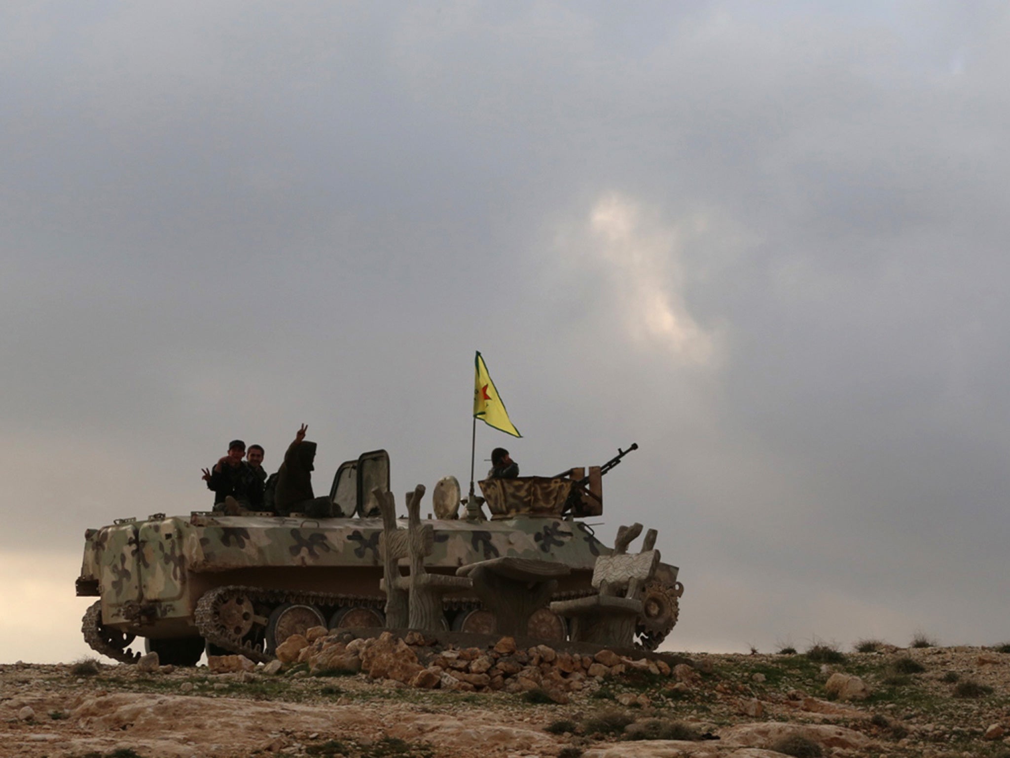 Kurdish YPG fighters flash victory signs as they ride in Sinjar after taking the city following extensive US air strikes