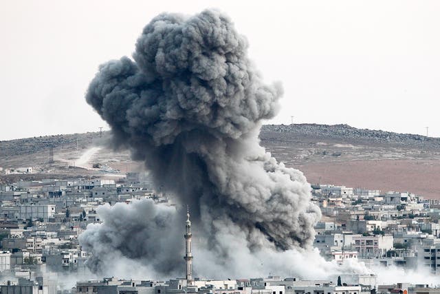 (File) Heavy smoke rises following an air strike by the US-led coalition in Kobani, Syria