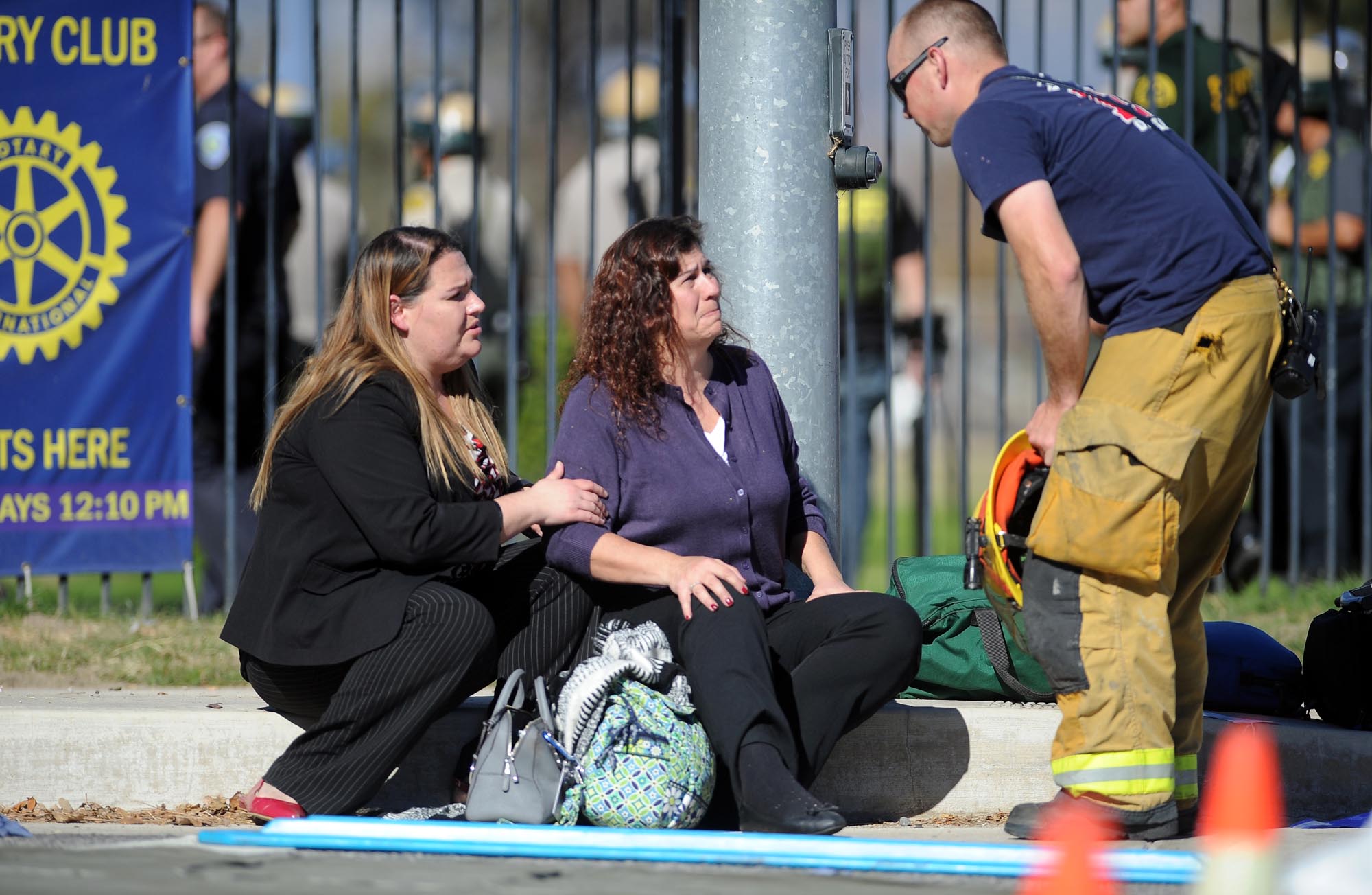 Two women speak with a firefighter near the scene. Micah Escamilla/Los Angeles News Group/Associated Press