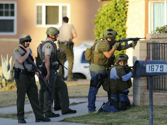 Police officers conduct a manhunt after the mass shooting in San Bernardino, California