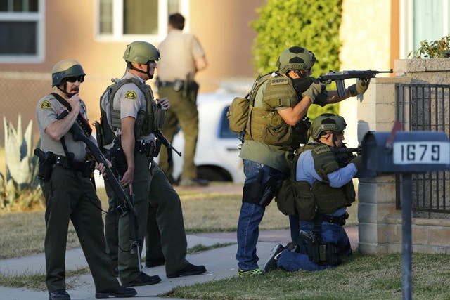 Police officers conduct a manhunt after the mass shooting in San Bernardino, California
