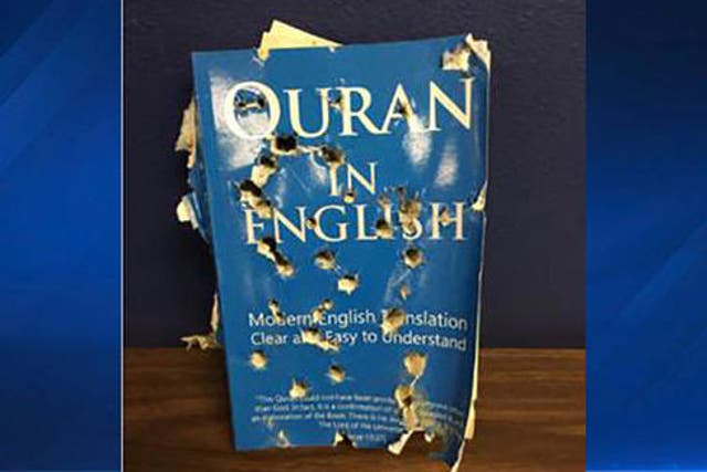 An English translation of the Quran pierced with multiple holes