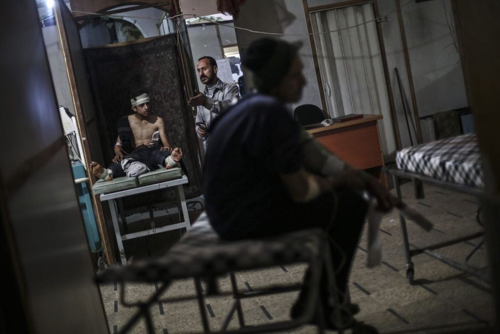 Wounded Syrians are treated in a makeshift medical facility