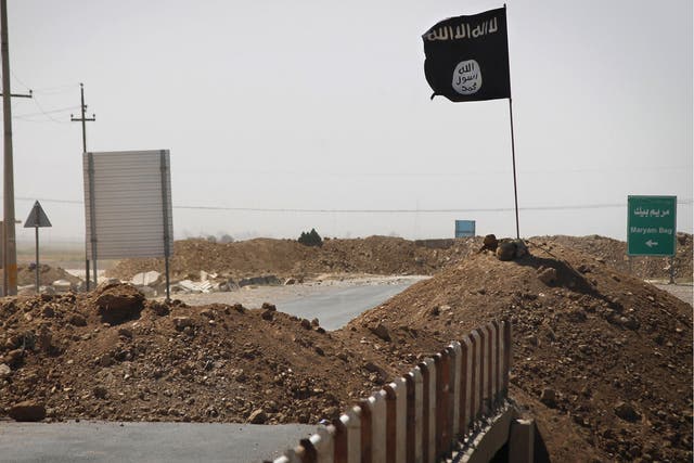 A flag of the Islamic State (Isis) is seen on the the frontline of fighting in Iraq