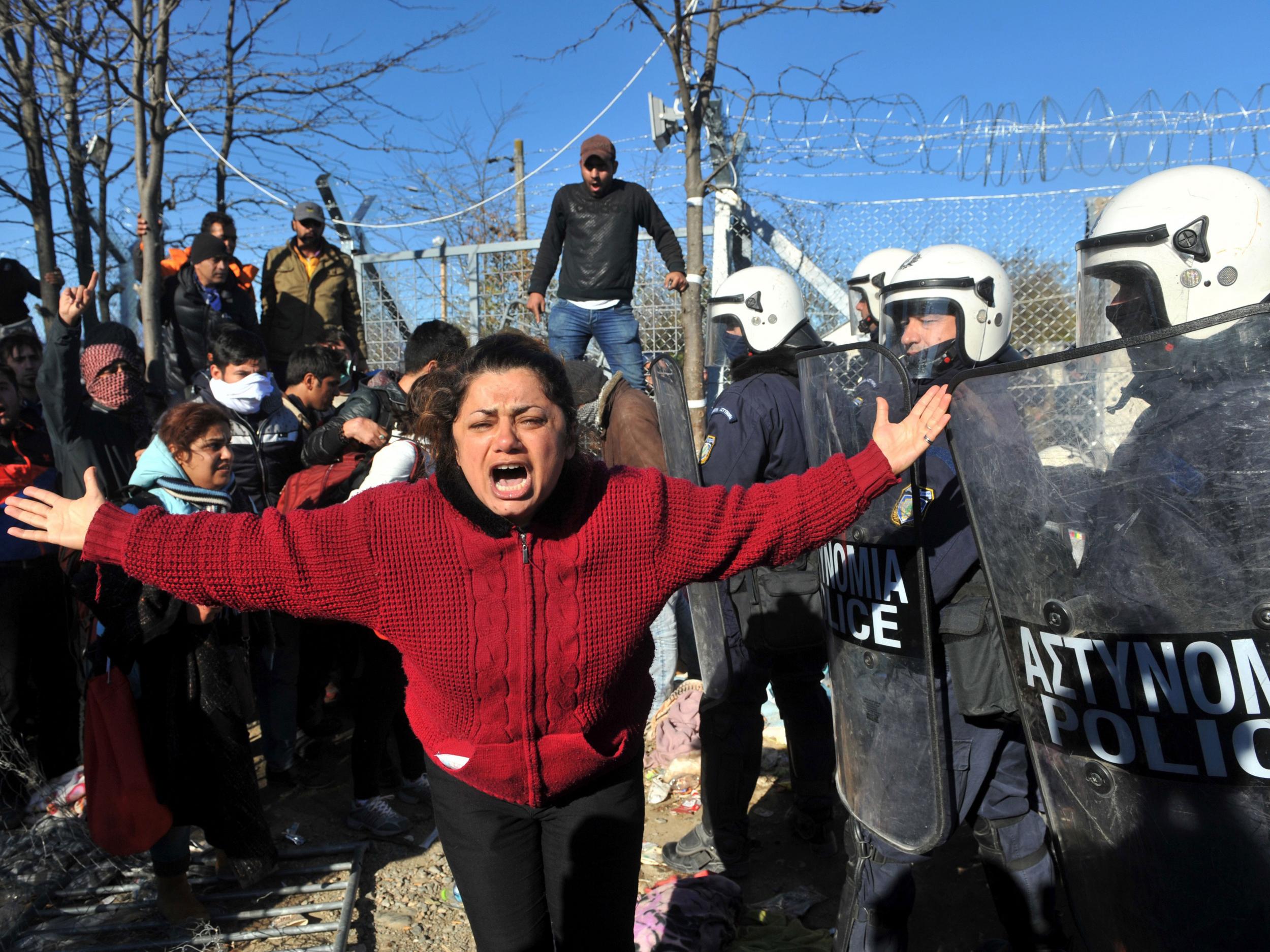 Refugees clash with Greek police as they wait to cross the Greek-Macedonian border