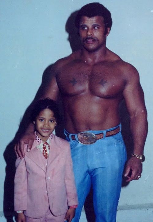 Just a young Dwayne Johnson rocking a pink suit next to ...