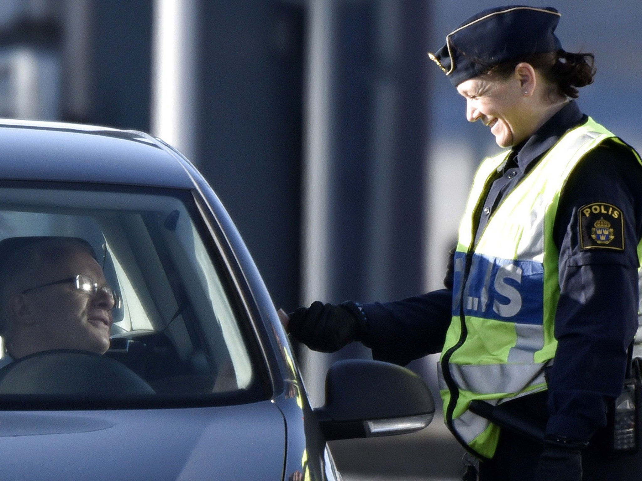 A police officer checks legitimation from a driver from Denmark at Lernacken on the Swedish side of the Oresund strait November 12, 2015.
