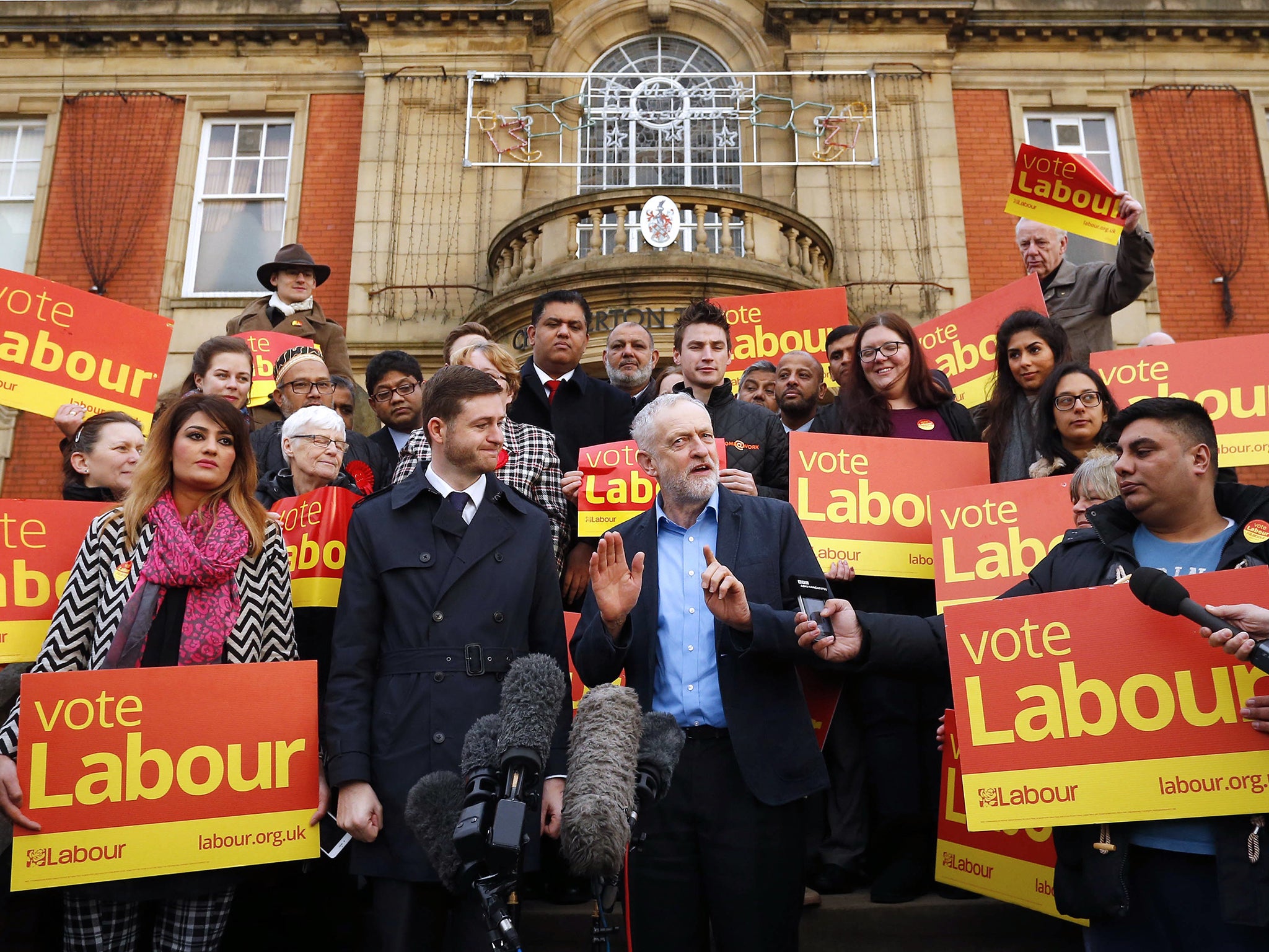 Mr Corbyn shared a celebratory hug with Mr McMahon on the steps of Chadderton Town Hall