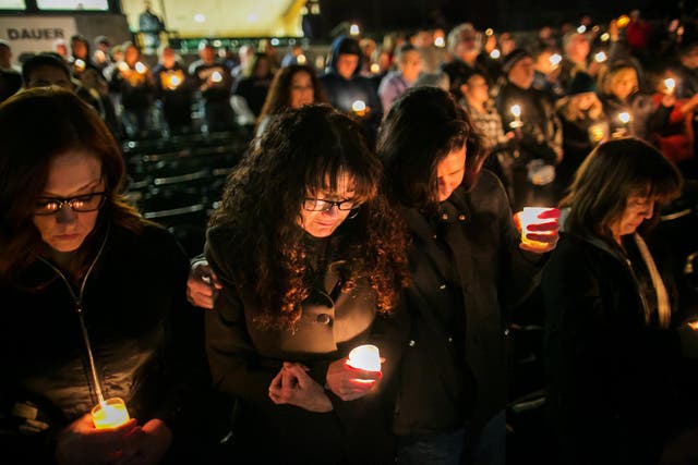 People attend a vigil for shooting victims in San Bernardino.
