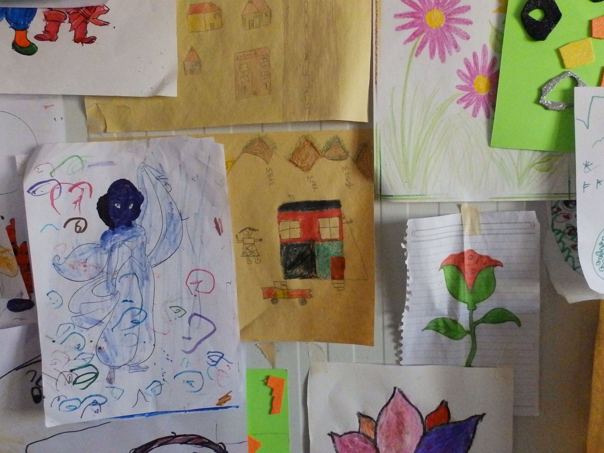 Houses can be seen among the pictures drawn by children at a centre run by Save the Children at Kara Tepe refugee camp, Lesbos, in November 2015