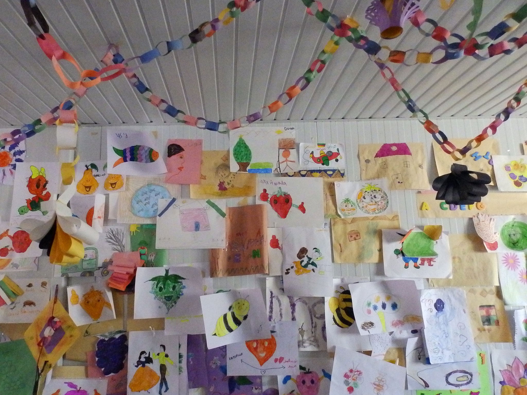 Houses can be seen among the pictures drawn by children at a centre run by Save the Children at Kara Tepe refugee camp, Lesbos, in November 2015