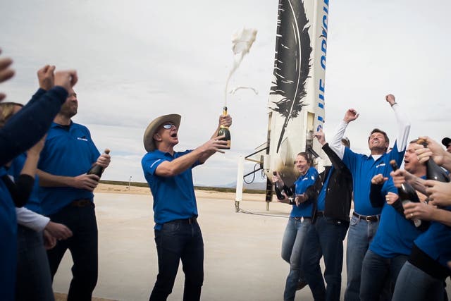 Blue Origin staff celebrate at the New Shepard landing site
