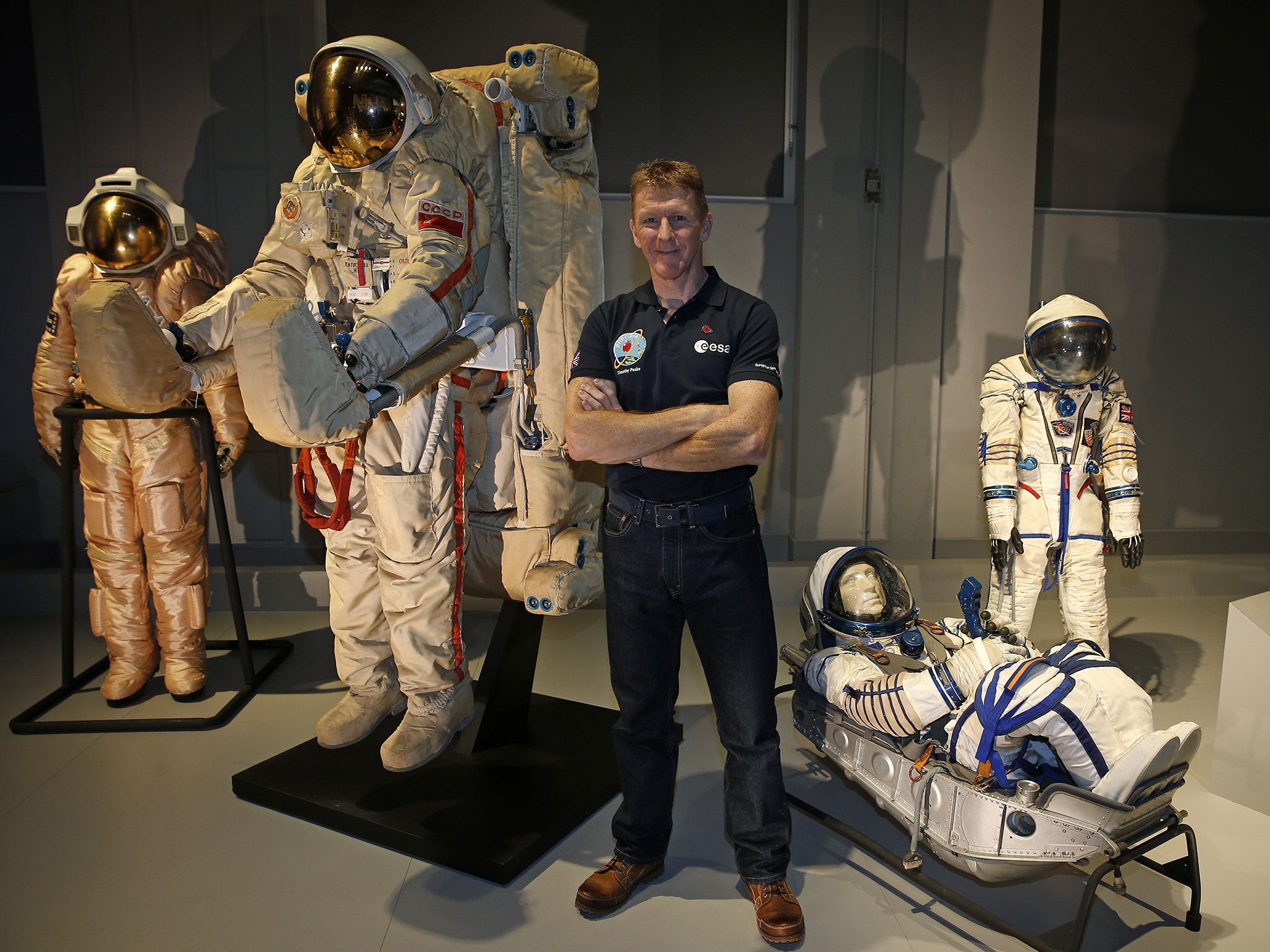 British astronaut Tim Peake looks stands among old space suits on display at the Science Museum in London on 6 November, 2015